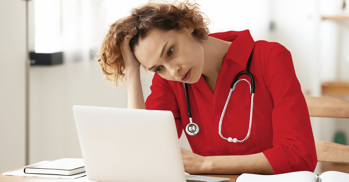 anxious healthcare staff staring at a laptop screen