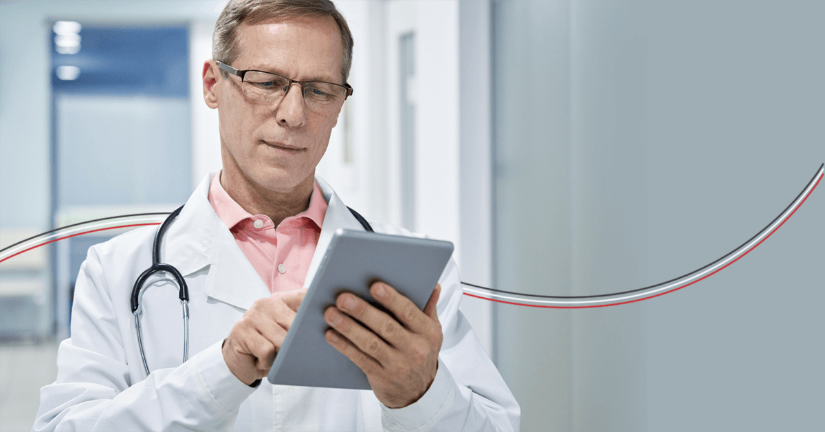 doctor using a tablet device for healthcare data analytics